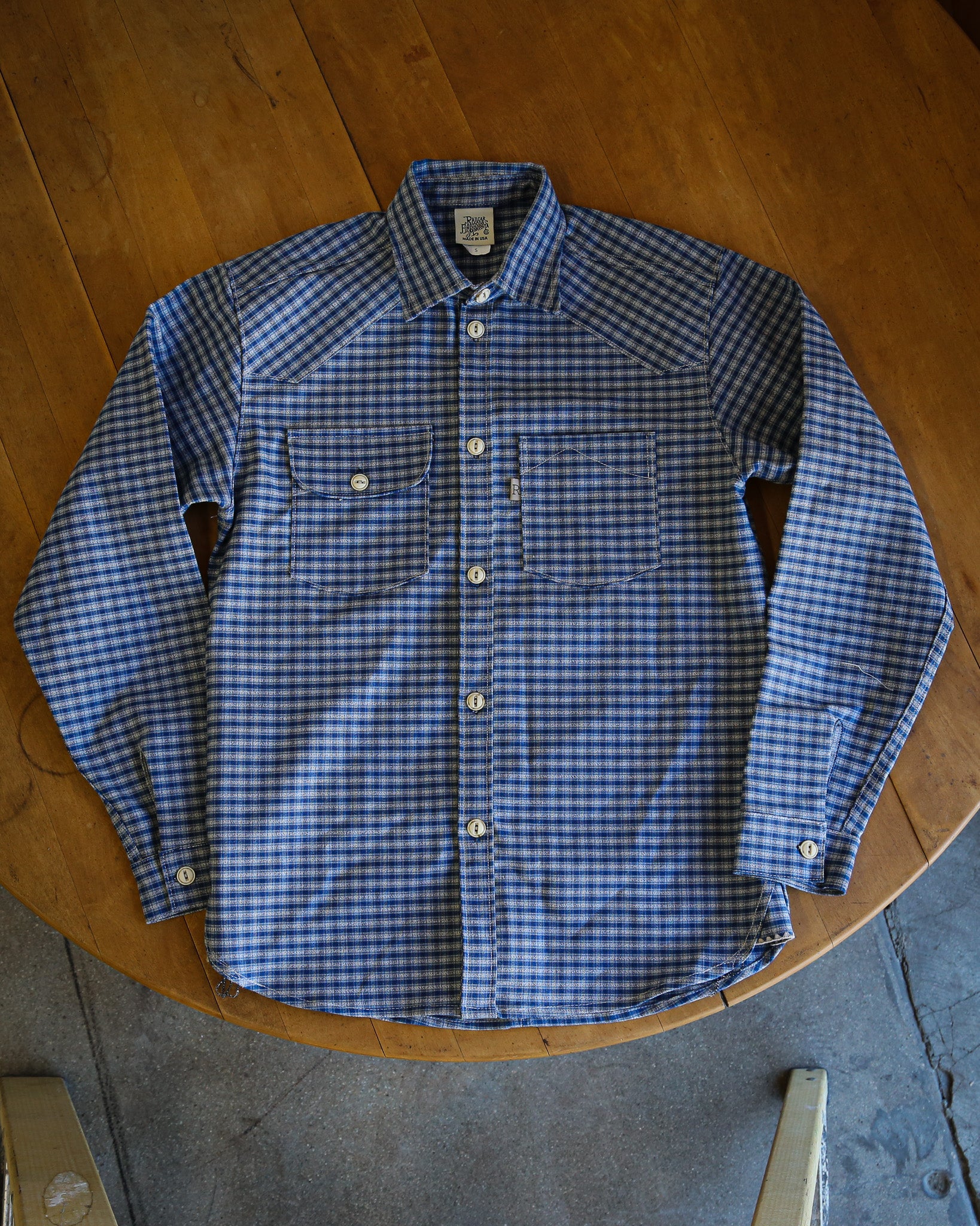 Blue checkered shirt on a wooden surface