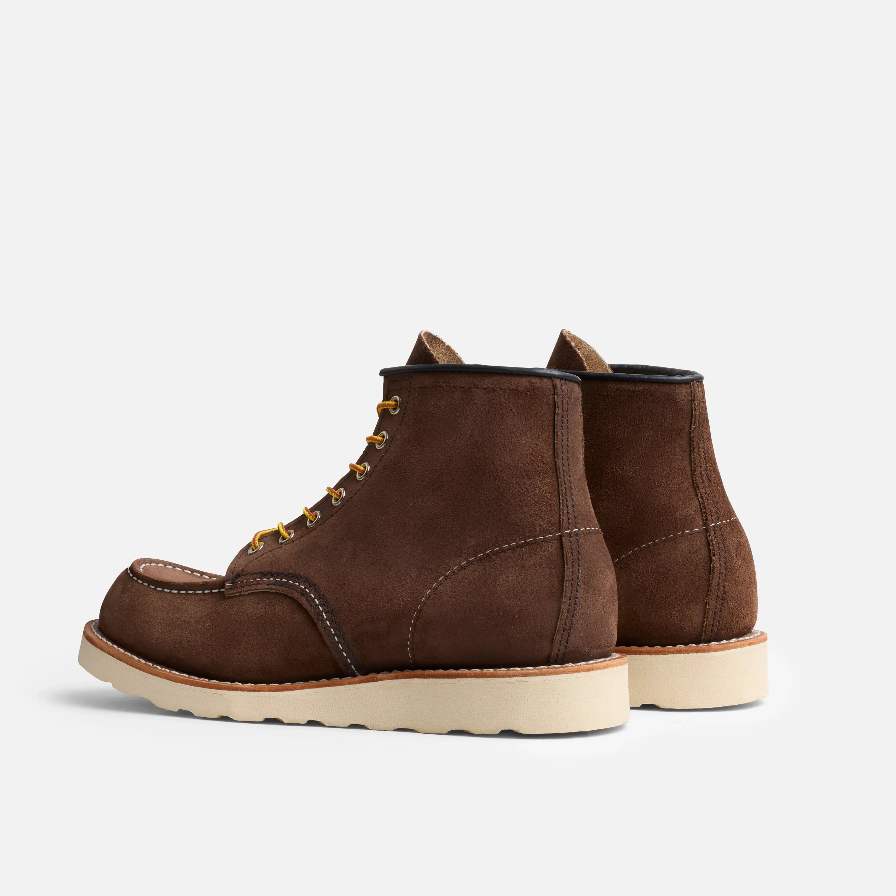 Pair of brown leather boots on a light gray background