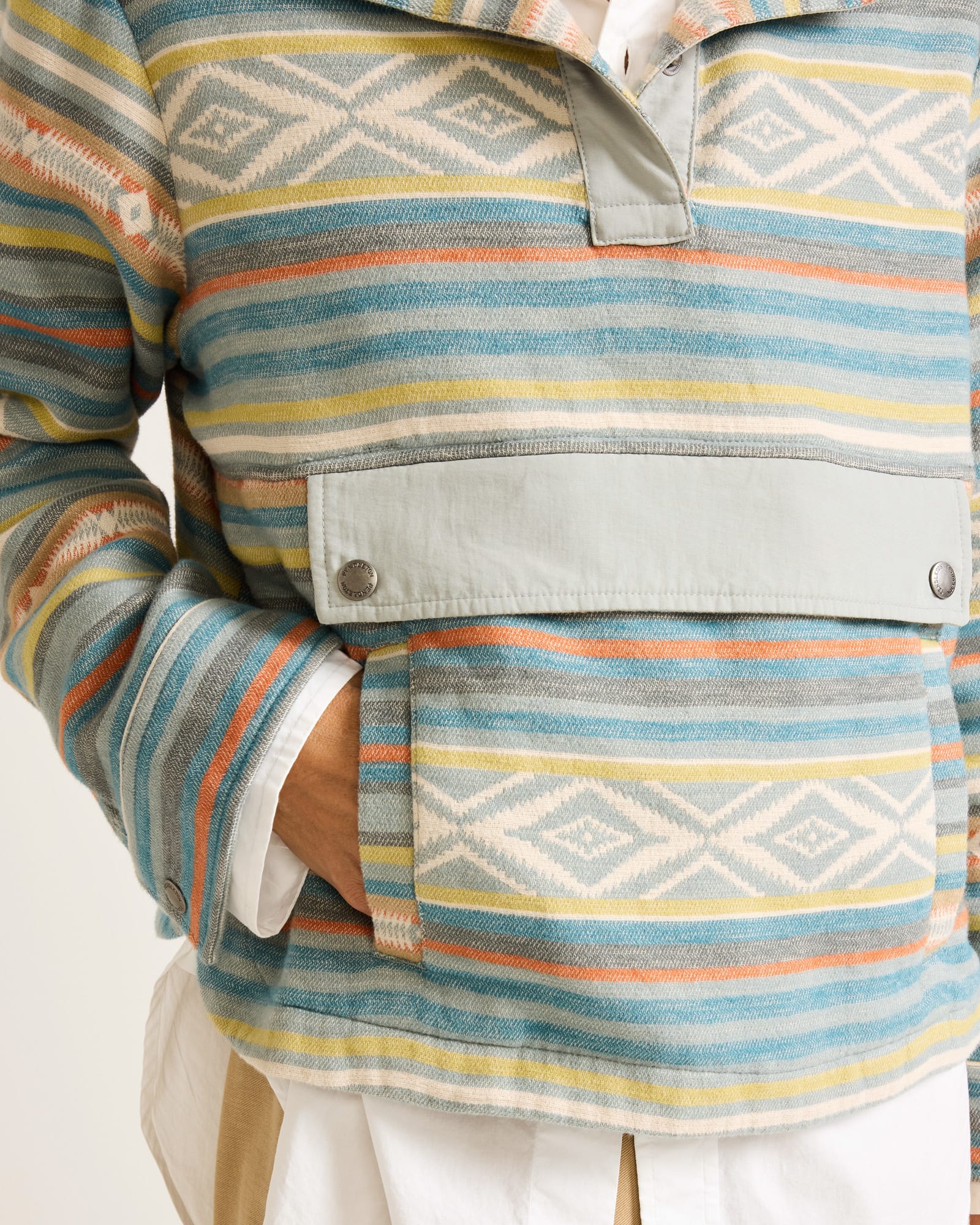 Multicolored striped jacket with geometric patterns on a white background