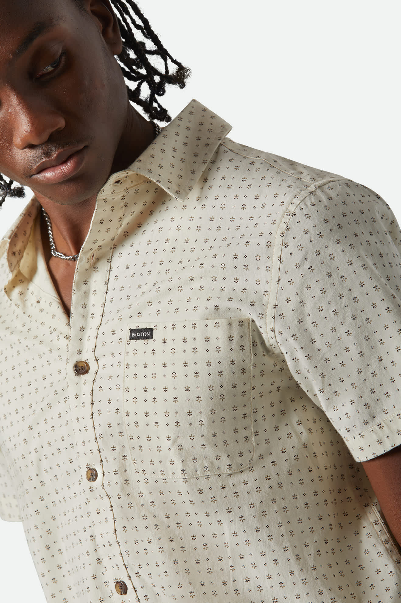 Model Photo Close Up of Brixton Men's Charter Print Short Sleeve Woven - Off White Micro Floral 