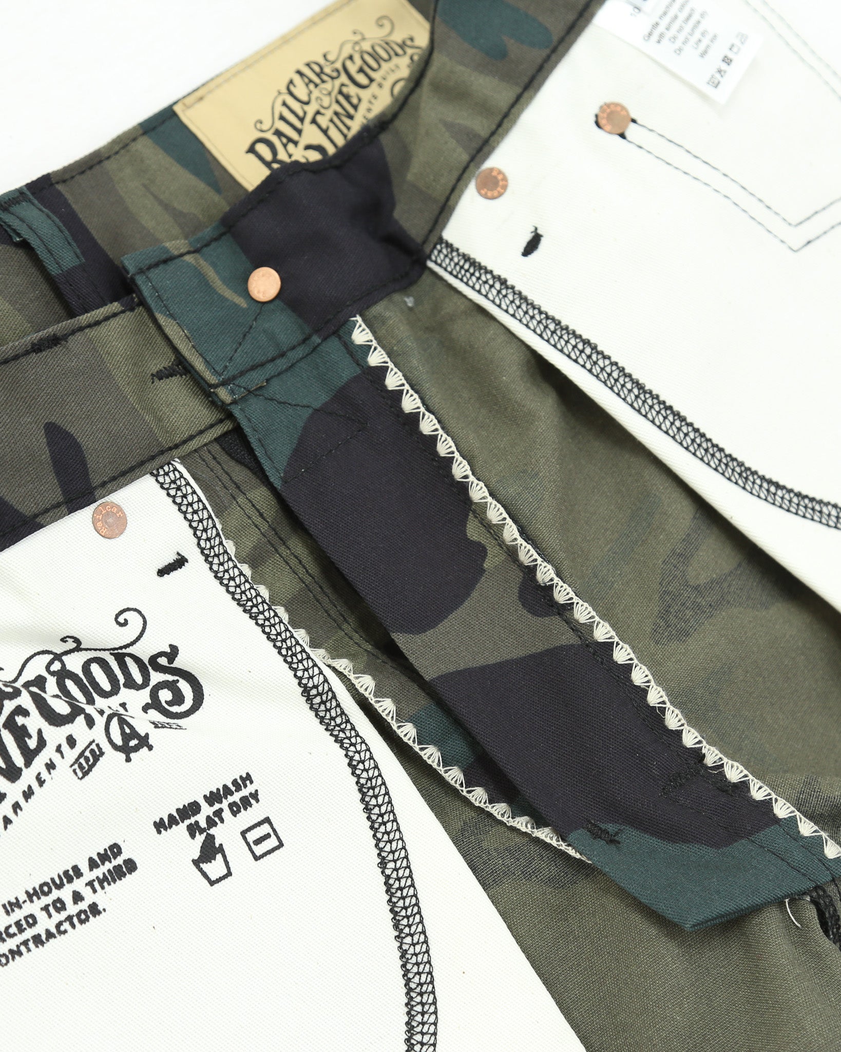 Close-up of a camouflage pants with brand labels and care instructions.