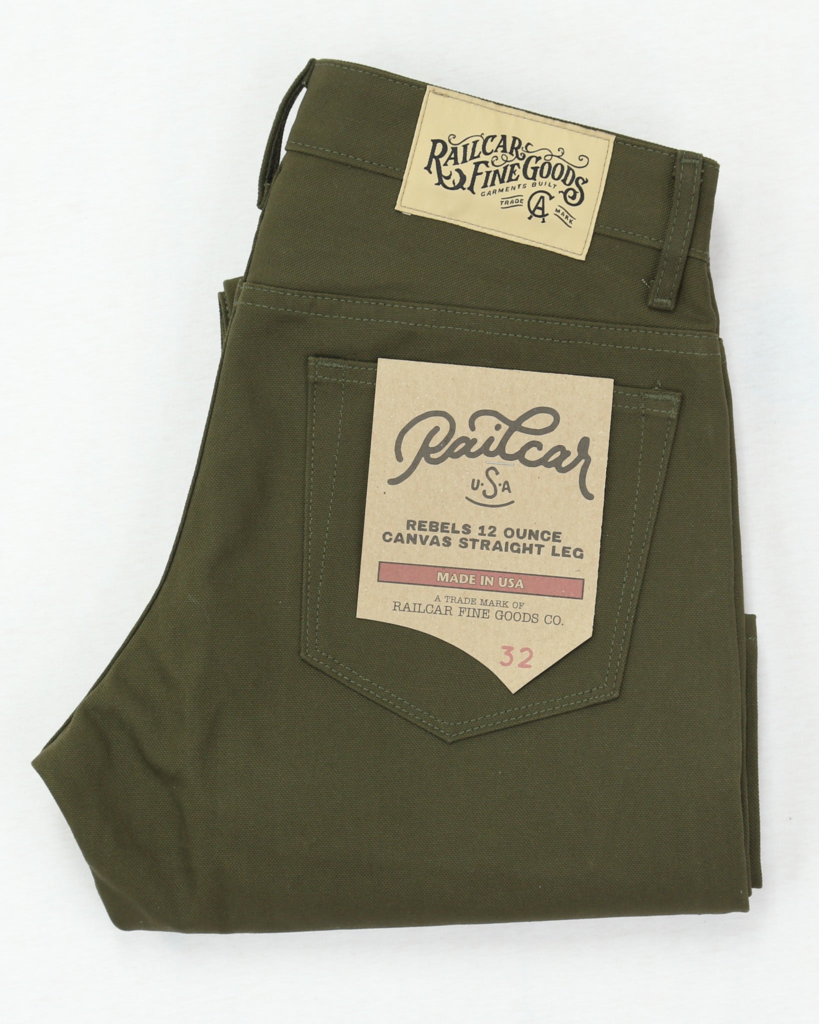 Green canvas pants with brand labels on a white background