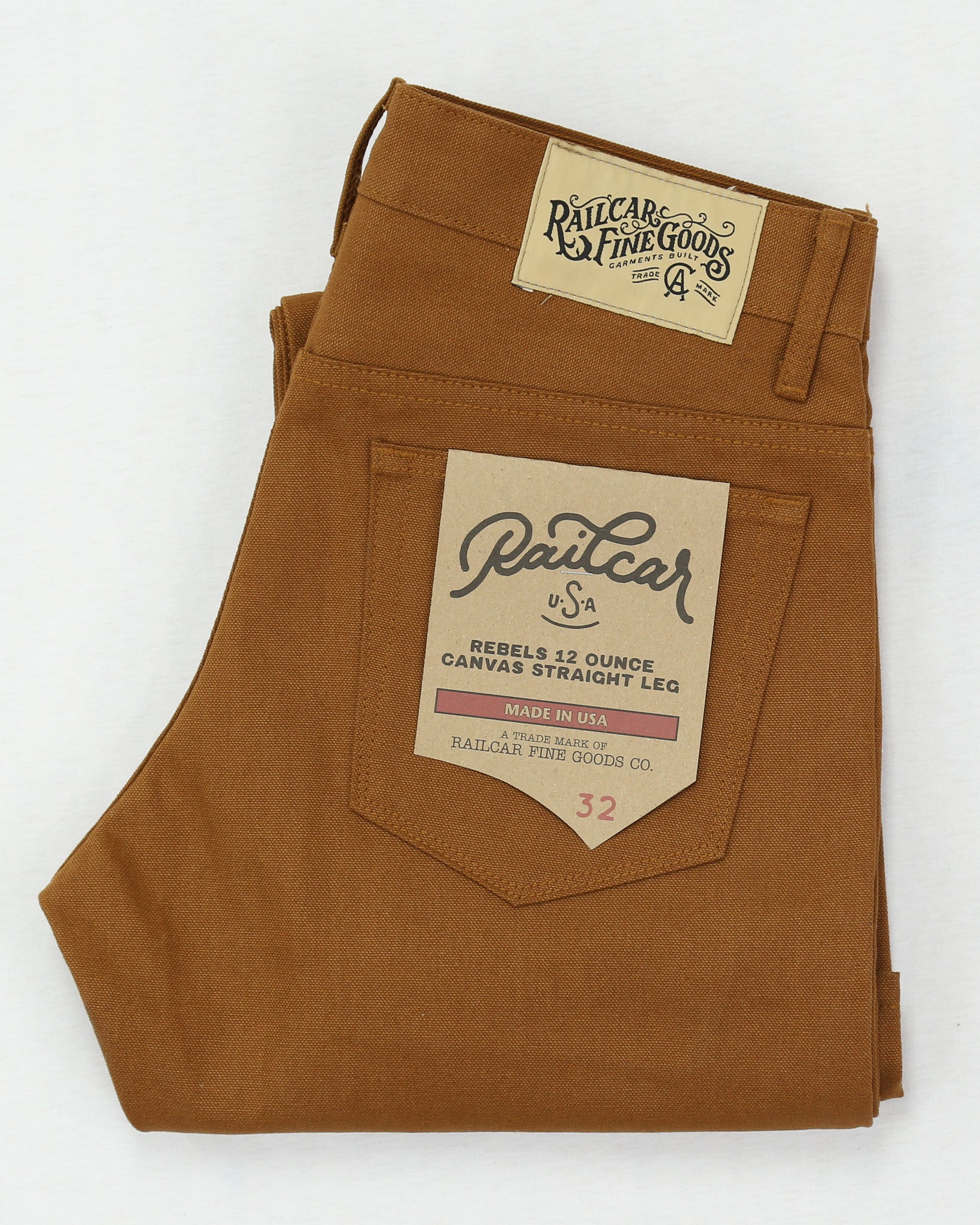 Brown canvas pants with a visible brand label on a white background