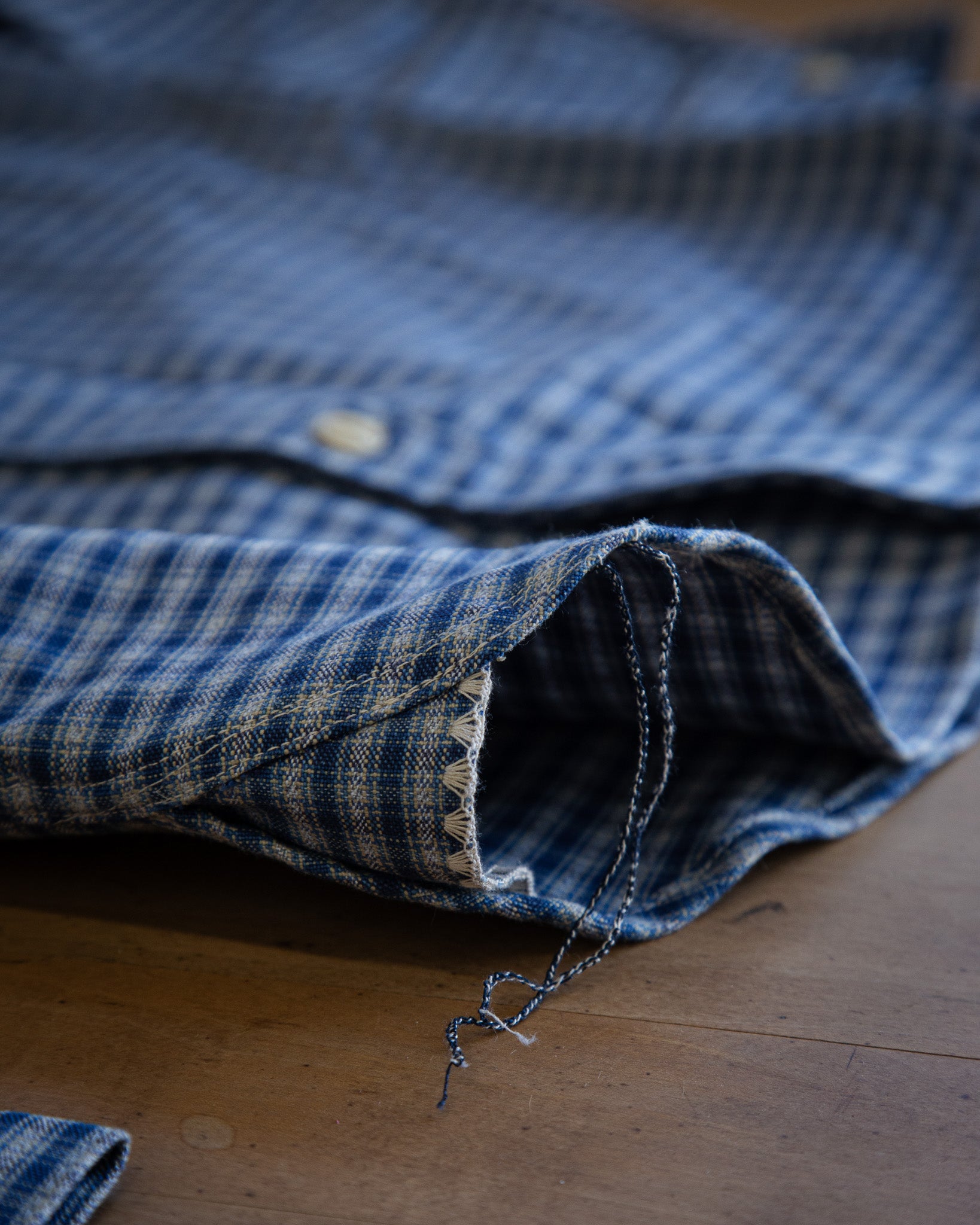 Folded blue denim shirt on a wooden surface