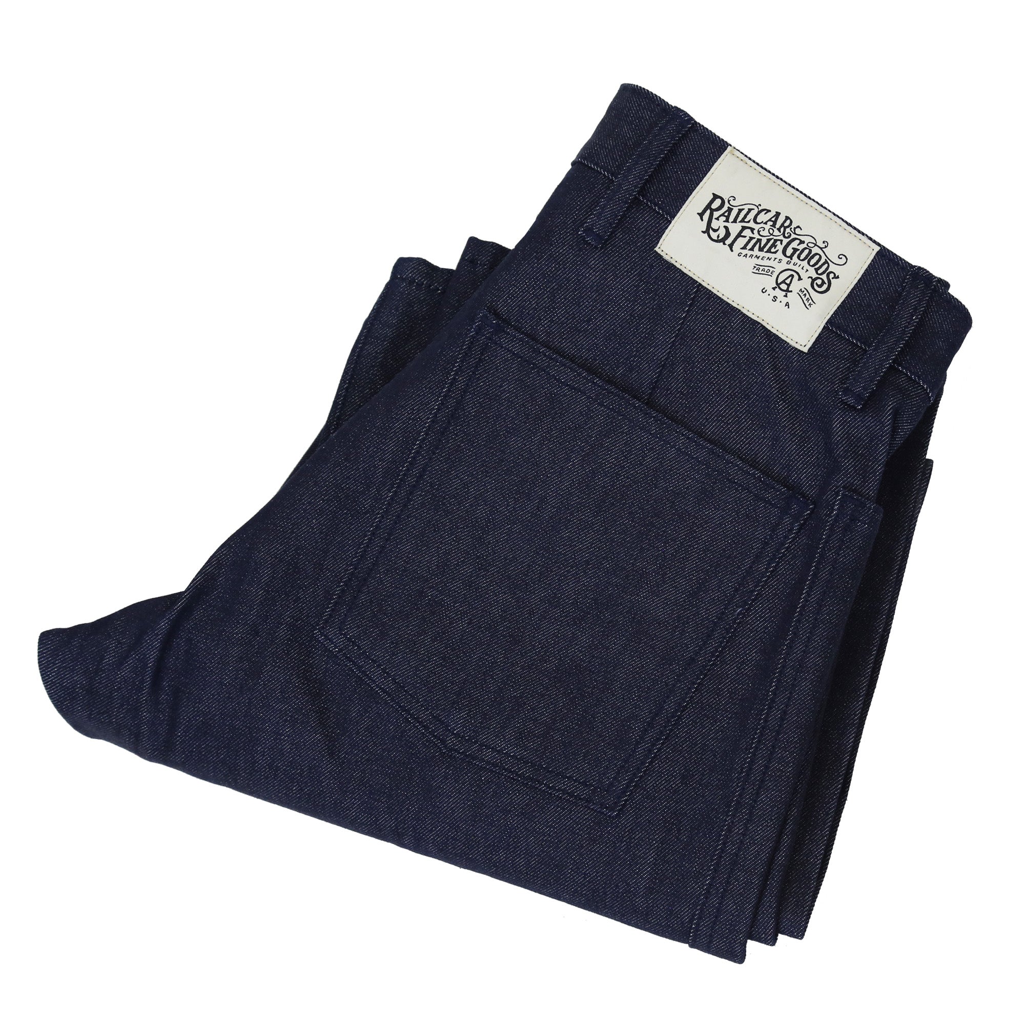A pair of folded Railcar Mariner unisex full leg jeans in classic indigo color, displaying back pocket and brand label.