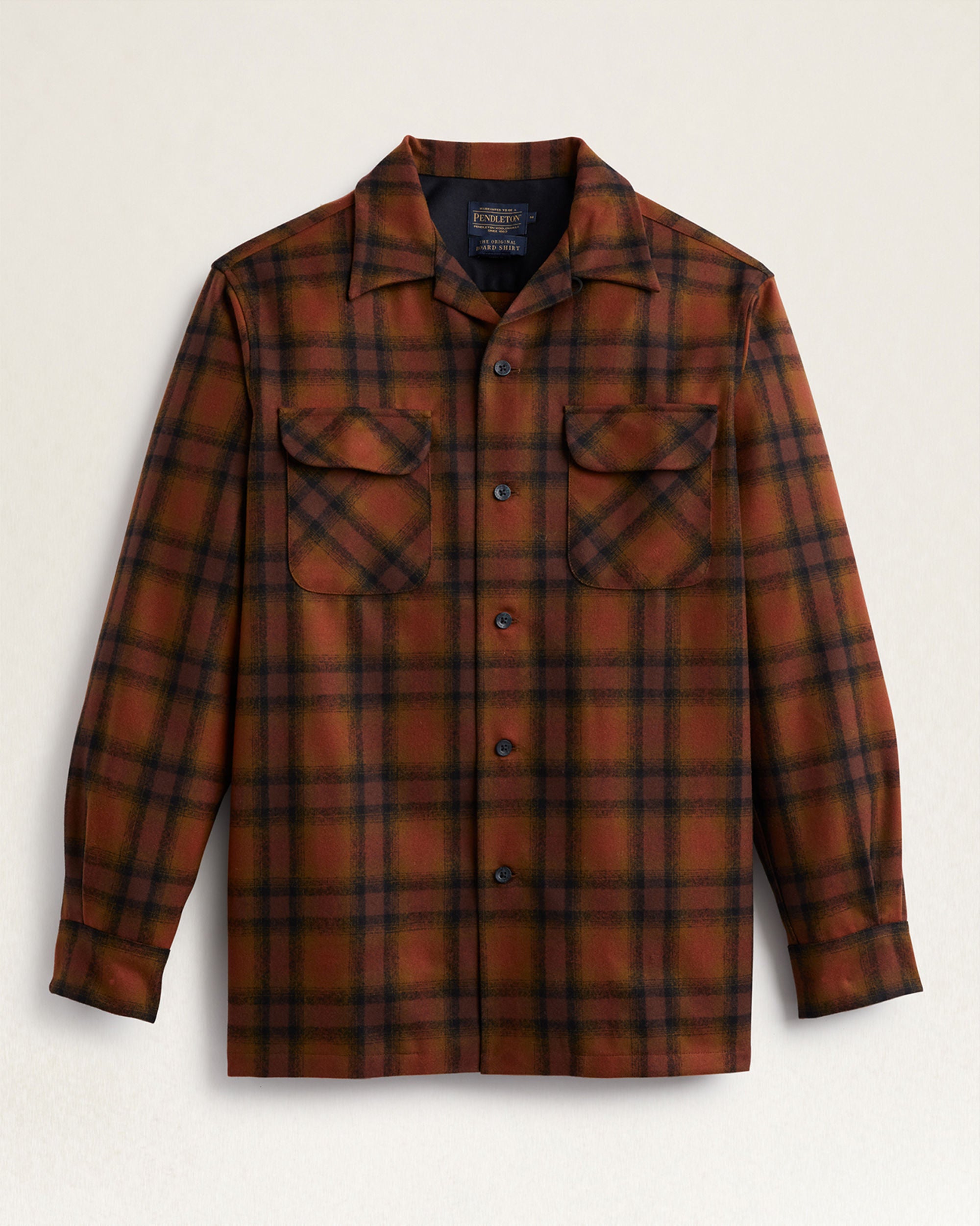 Plaid shirt with two front pockets on a light beige background