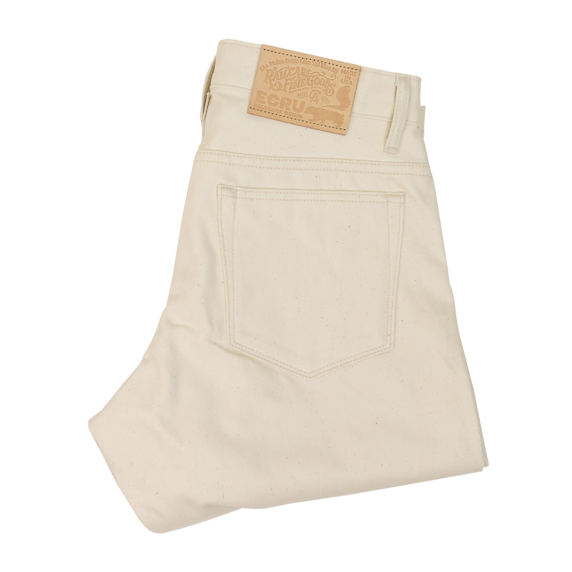 Folded Pair of  X105 12 Oz Ecru Natural Selvedge Jeans showing back pocket and leather