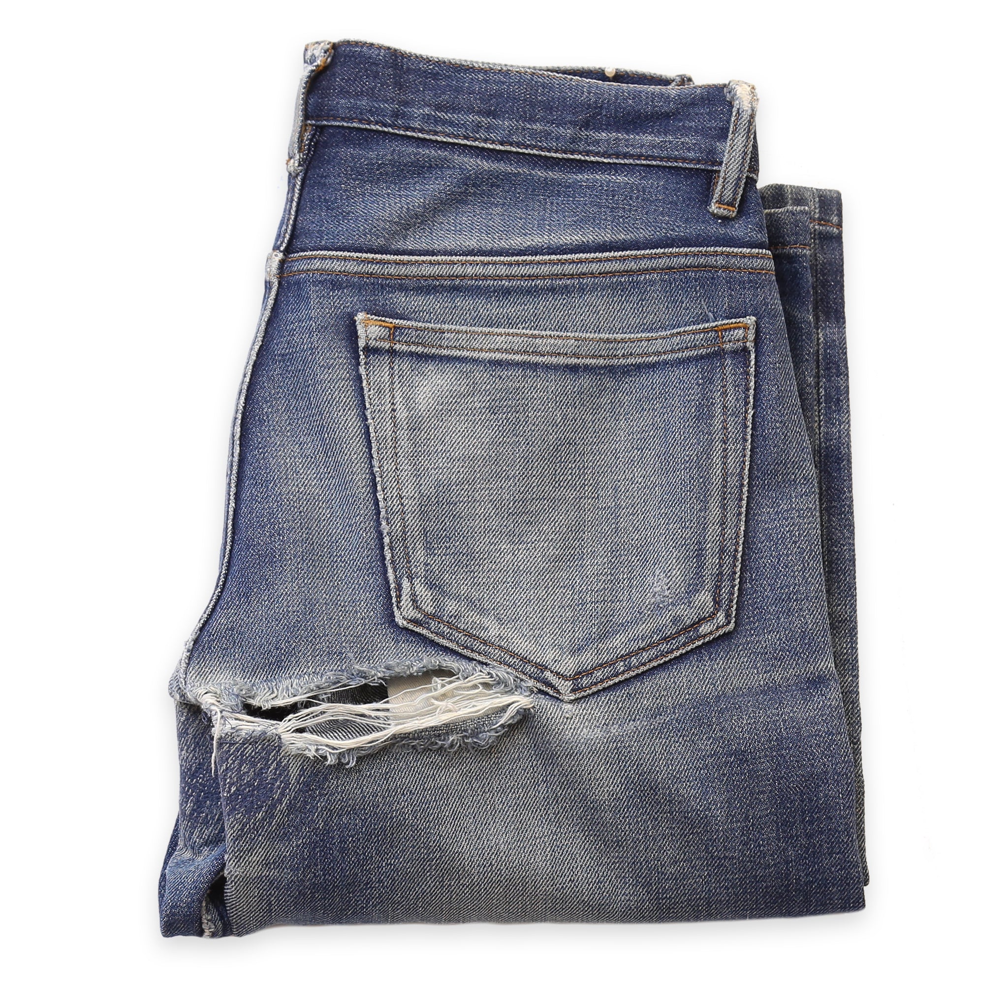 A pair of denim jeans with a hole in the crotch area, ready for repair.